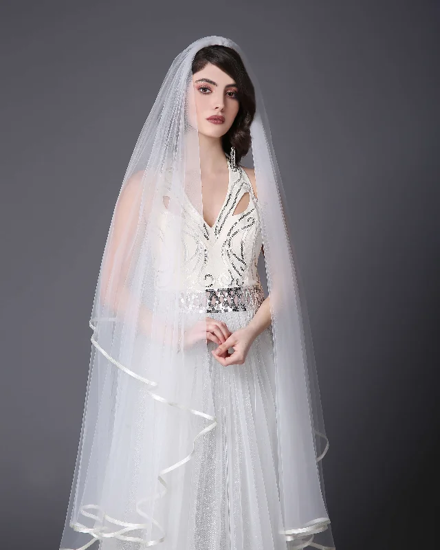 Knee-length veil with finishing tape.